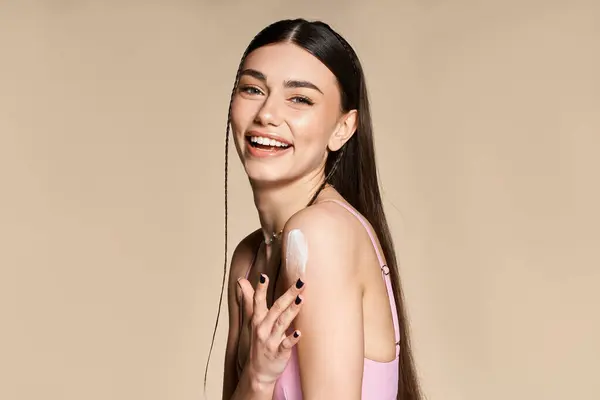 Bright summer day brings joy as a young woman applies sunscreen, embracing the sun's warmth. — Stock Photo