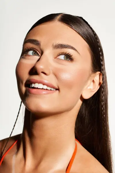 Bright smile of a young woman enjoying summer while applying sun protection on her skin. — Stock Photo
