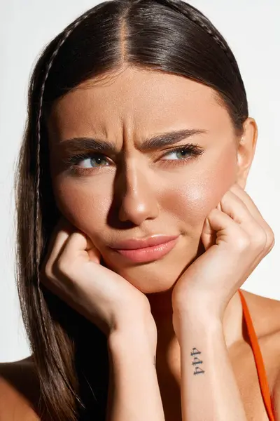 Young woman with a sun tan reflects on summertime while playfully posing indoors. — Stock Photo