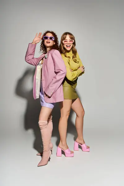 Two young women express their love and individuality through fashion, smiling joyfully in a studio. — Stock Photo