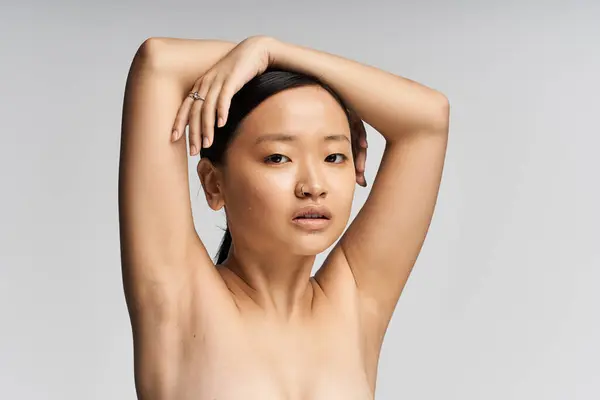 A woman displays her poise and elegance with arms lifted, embracing her inner beauty and strength. — Stock Photo