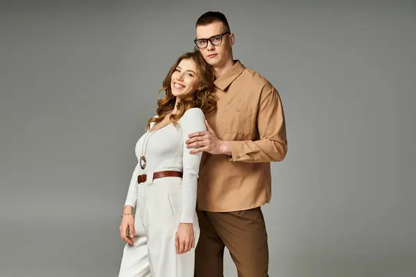 Beautiful couple smiles as they embrace in a stylish studio filled with warmth and joy — Stock Photo