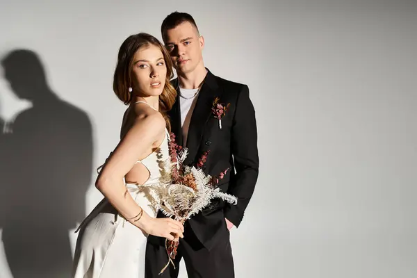 Beautiful young couple poses gracefully, radiating joy and romance against a minimalist backdrop. — Stock Photo