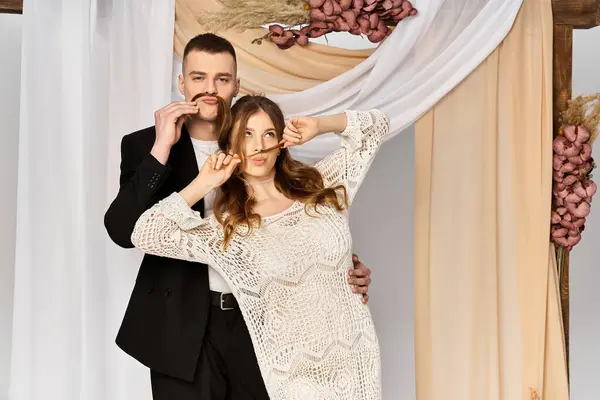 Bride and groom share a lighthearted moment while showcasing their playful side at a wedding venue. — Stock Photo