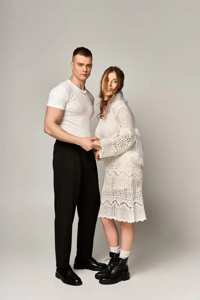 Young couple expresses romance and beauty while holding hands, radiating happiness and elegance. — Stock Photo