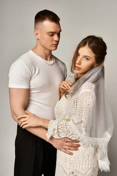 A stunning bride and groom pose affectionately, radiating romance in their elegant attire. — Stock Photo