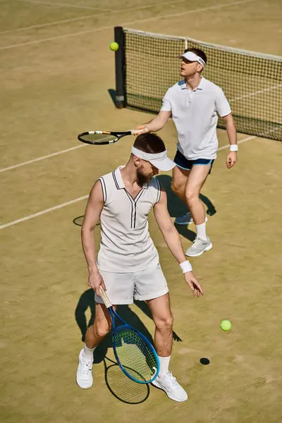Handsome players showcase their skills on the court while enjoying a sunny summer afternoon. — Stock Photo
