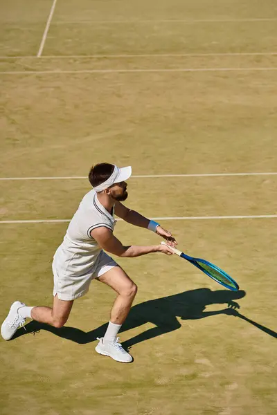 A talented player swings his racquet on a sunny day at the tennis court, enjoying summer sports. — Stock Photo