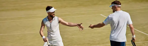 Handsome players engage in an exciting tennis match, smiling and competing on summer day, banner — Stock Photo