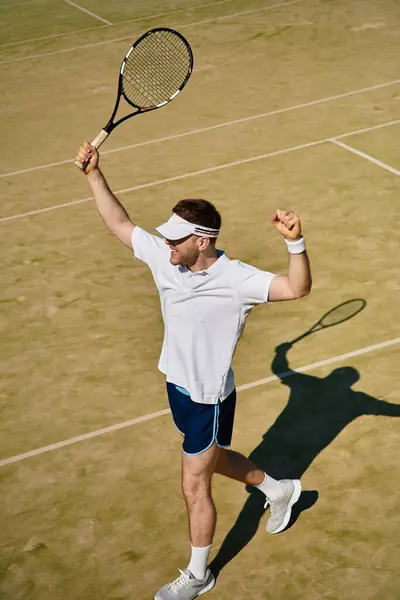 Athletic player enjoys summer tennis, showcasing his skills in white sportswear on court. — Stock Photo