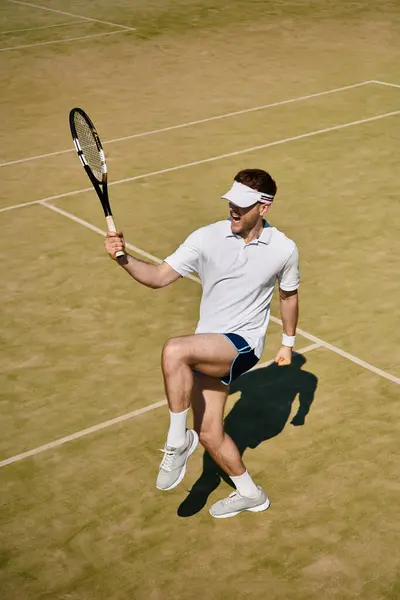 Handsome man celebrates a winning shot while playing tennis on the sunny court. — Stock Photo