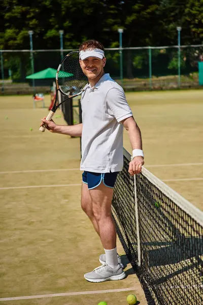 A skilled player shows off his talent on the court in bright summer weather, dressed in white. — Stock Photo