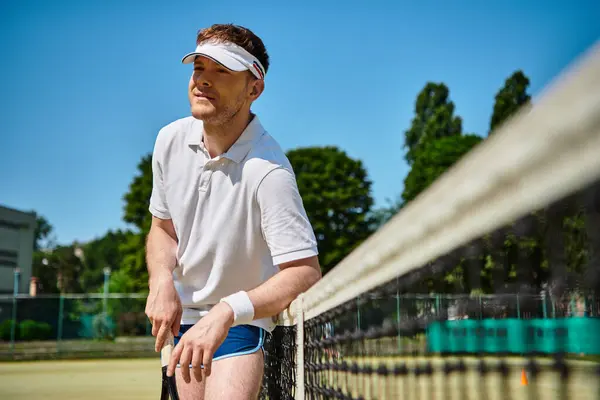 A talented player showcases his skills on a vibrant tennis court under a clear summer sky. — Stock Photo