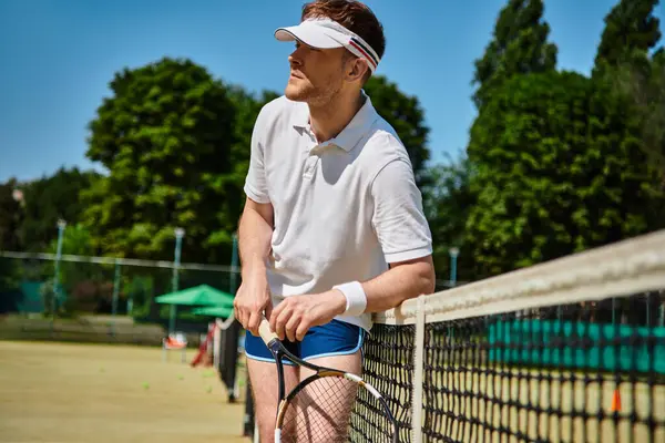 A skilled player engages in an intense tennis match on a sunlit court during summer. — Stock Photo