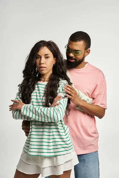 Fashionable man and woman express love and connection while embracing in a modern space. — Stock Photo