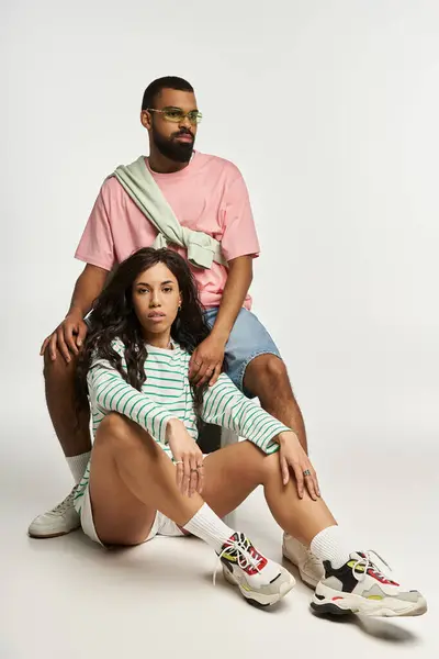 A couple showcases their unique fashion sense while posing together with affection and elegance. — Stock Photo