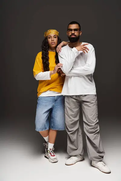 A couple exudes confidence and style, standing side by side in a modern, minimalist setting. — Stock Photo