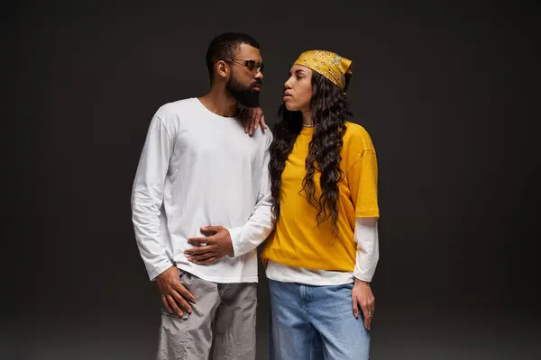 Couple showcases trendy outfits while expressing love and connection in a modern setting. — Stock Photo