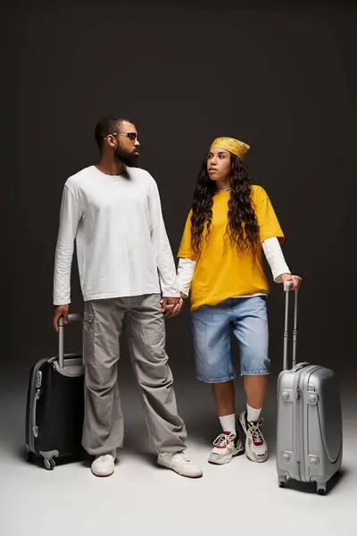 Couple displays their fashion sense as they prepare for an adventure together in style. — Stock Photo