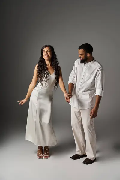 A man and woman express love and playfulness while dressed in chic outfits, radiating romance. — Stock Photo