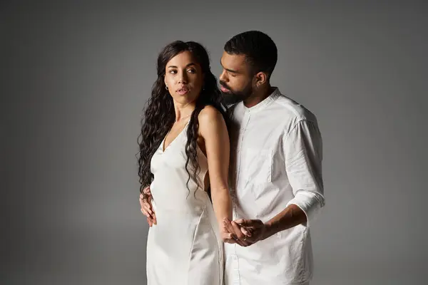A couple exudes love and elegance, dressed in chic outfits, embracing each other warmly. — Stock Photo