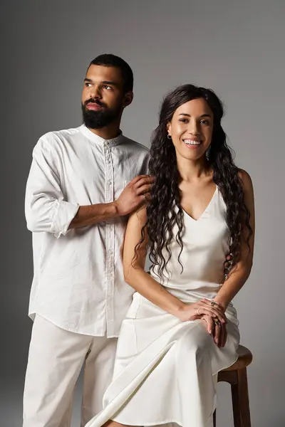 A couple exudes charm and sophistication while posing together in stylish outfits, radiating love. — Stock Photo