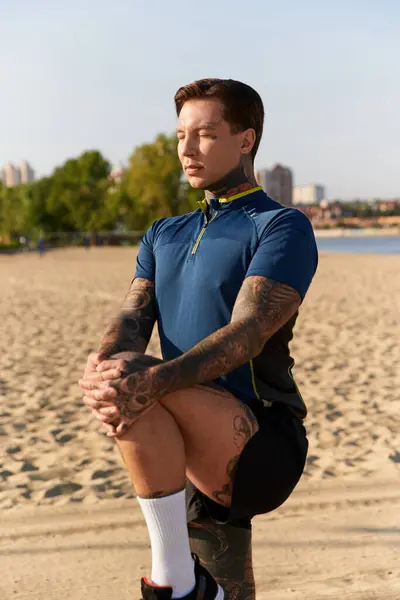 Young man poses thoughtfully on the sandy beach, appreciating nature and the moment. — Stock Photo