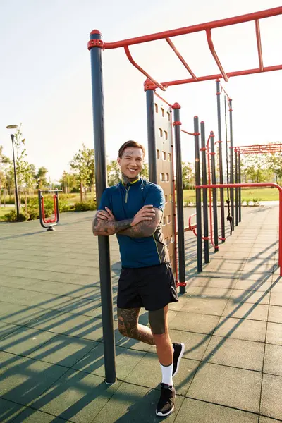 A young man strolls contently through a sunny park, surrounded by vibrant greenery. — Stock Photo