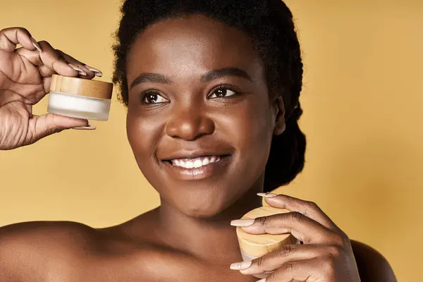 Bright atmosphere as a young woman with radiant skin demonstrates beauty products with joy. — Stock Photo