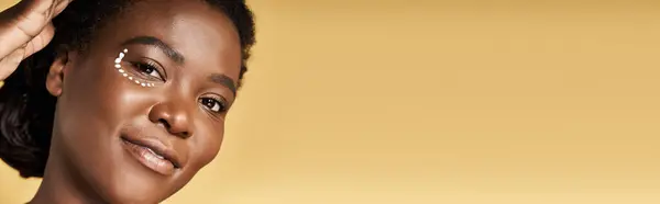 Young African American woman showcases her radiant skin with a beauty focus in the studio, banner — Stock Photo
