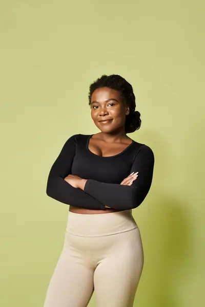 A young African American woman showcasing dedication to sport in a vibrant studio environment. — Stock Photo