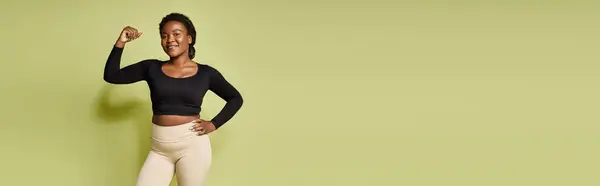 Young fit african american sportswoman confidently poses after an intense workout session, banner — Stock Photo