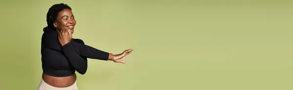 A young Black athlete enjoys a workout in a bright vibrant studio, banner — Stock Photo
