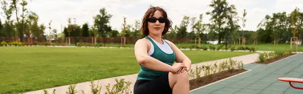 A determined young woman showcases her strength with an outdoor fitness routine on a bright day, banner — Stock Photo