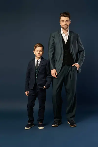 Father and son wear elegant suits and share a joyful moment together, celebrating Father Day. — Stock Photo