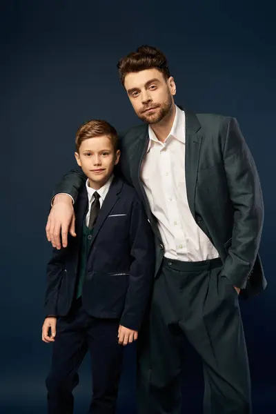 A father and son dressed elegantly posing together in a festive atmosphere. — Stock Photo
