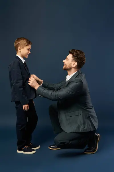 A father lovingly adjusts his sons suit for a special celebration of Father Day 2025. — Stock Photo