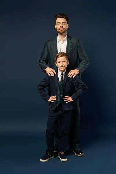 A man and a boy share a joyful moment, showcasing their festive attire for Fathers Day 2025. — Stock Photo