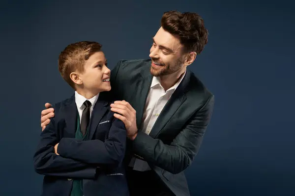 A joyful father smiles at his son, celebrating togetherness on Fathers Day in 2025. — Stock Photo