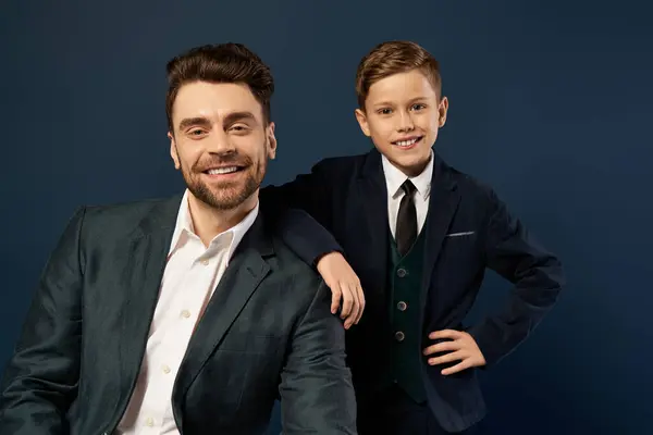 A smiling father and son share a warm moment, celebrating togetherness in elegant attire. — Stock Photo