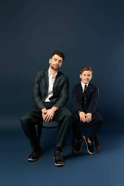 A father and son in elegant attire share a heartfelt moment, showing their love. — Stock Photo