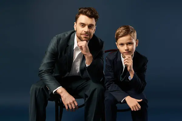 A father and son share a moment of joy, deep in thought, celebrating their bond on Fathers Day. — Stock Photo