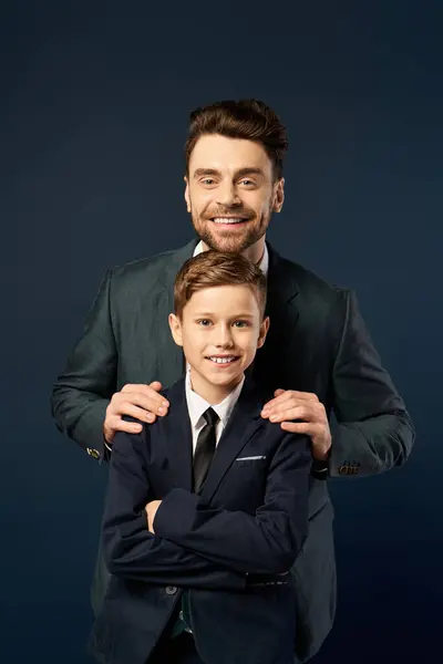 A father and son share a festive moment, smiling together in formal attire for Fathers Day. — Stock Photo