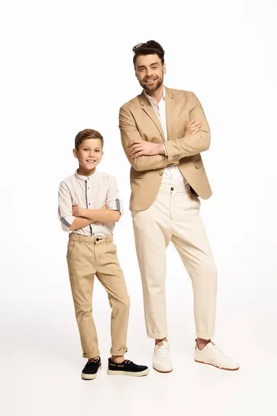 A father and son pose together, showcasing their stylish outfits and strong bond on Fathers Day. — Stock Photo