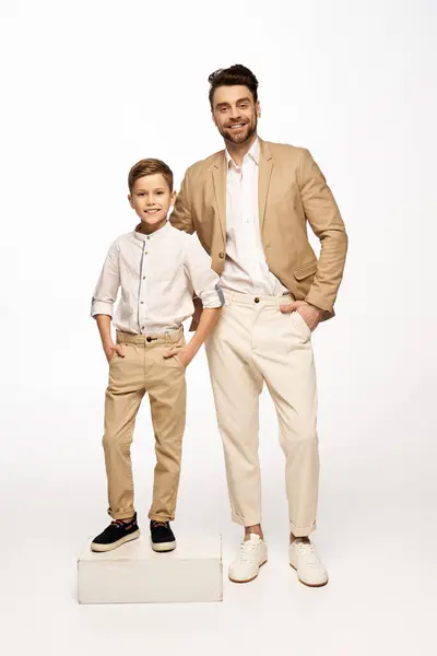 Cheerful father and son dressed elegantly, embracing the spirit of togetherness during Fathers Day. — Stock Photo