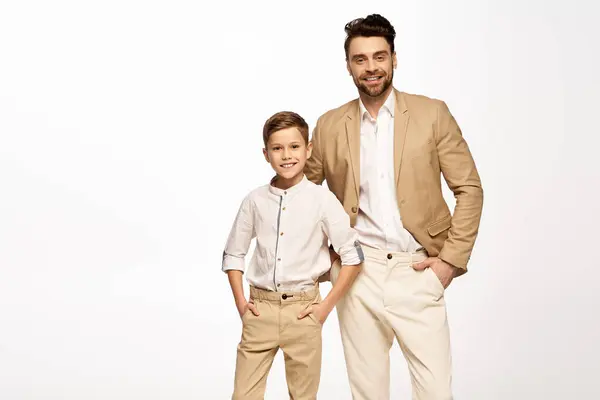 Father and son share smiles while dressed elegantly together for a festive celebration. — Stock Photo