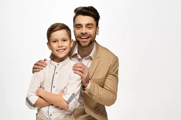 Father and son share a warm embrace and smile together in a moment of joy and togetherness. — Stock Photo