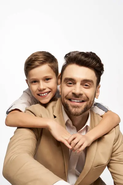 A cheerful father and son embrace, showcasing their happiness and love for each other. — Stock Photo