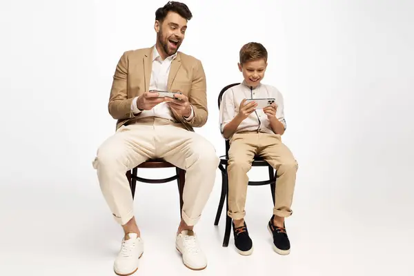 Father and son enjoying a playful gaming session, bonding and celebrating Fathers Day joyfully. — Stock Photo