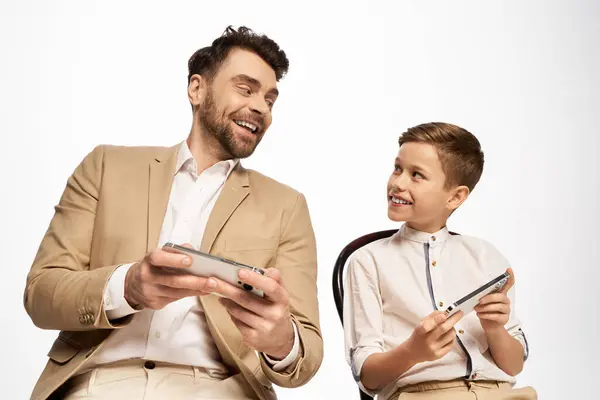 A father and son share a delightful gaming experience, showcasing their bond and happiness together. — Stock Photo